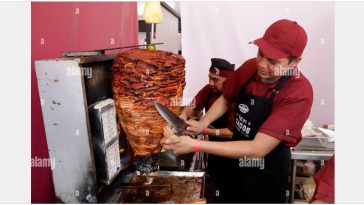 Taquero by Alarmy. A man preparing an Al Pastor taco.